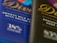 Two chocolate bar wrappers are positioned side by side, one visibly labeled as smooth milk chocolate with salted caramel and the other described as exquisite dark chocolate. Both wrappers feature elegant cursive typography.