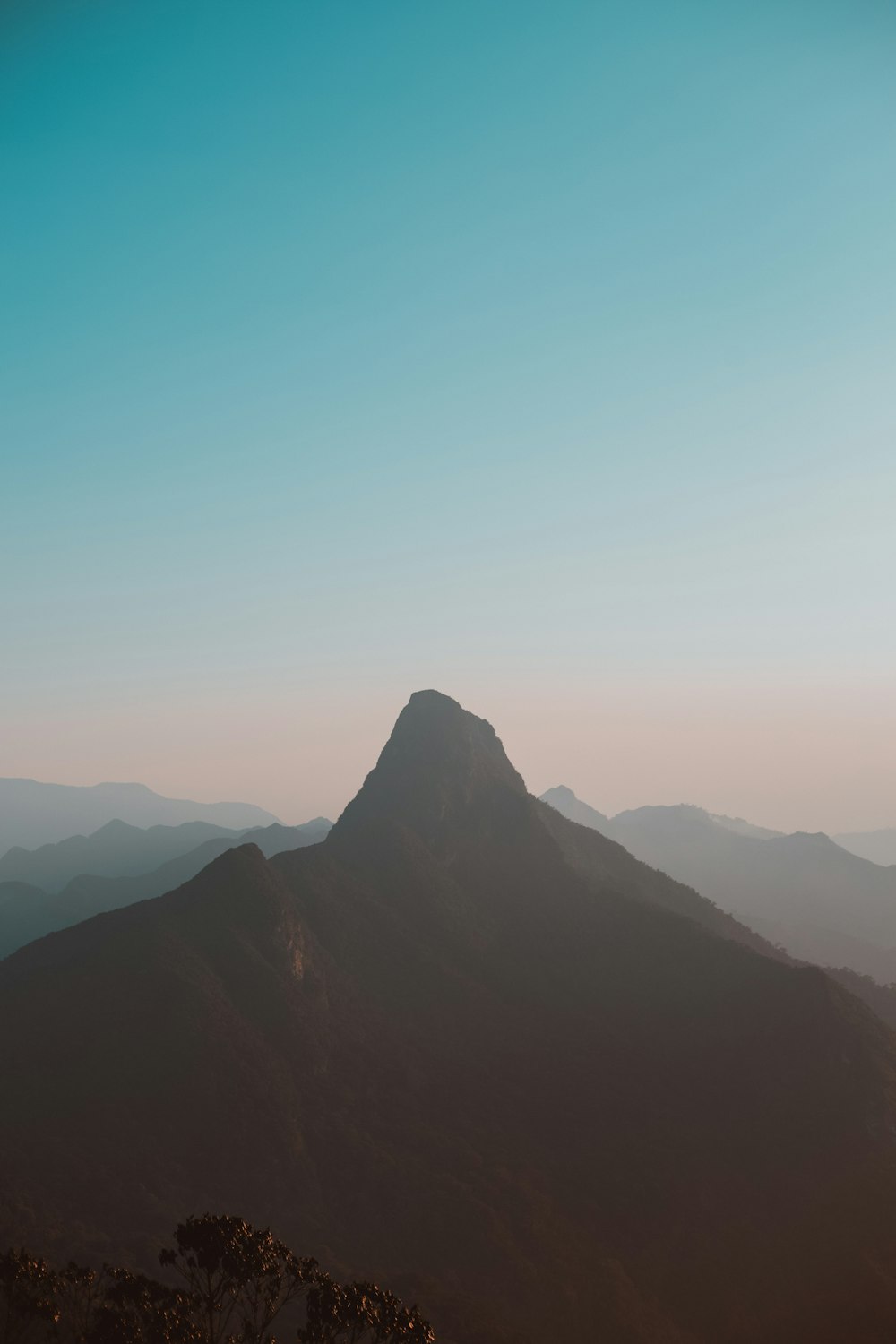 a view of a mountain with a blue sky in the background