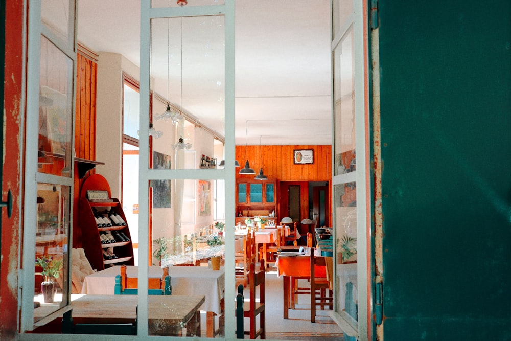 an open door leading to a dining room and kitchen