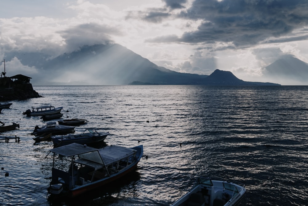 a group of boats floating on top of a body of water