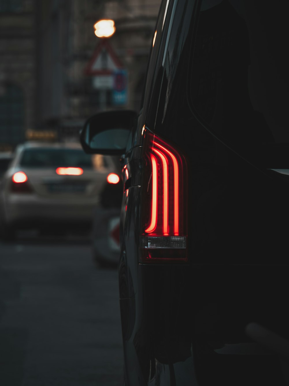 the tail lights of a car on a city street