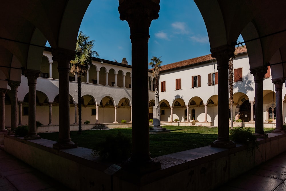 a courtyard with arches and a clock tower