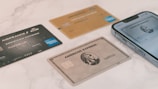 a group of credit cards sitting next to a cell phone