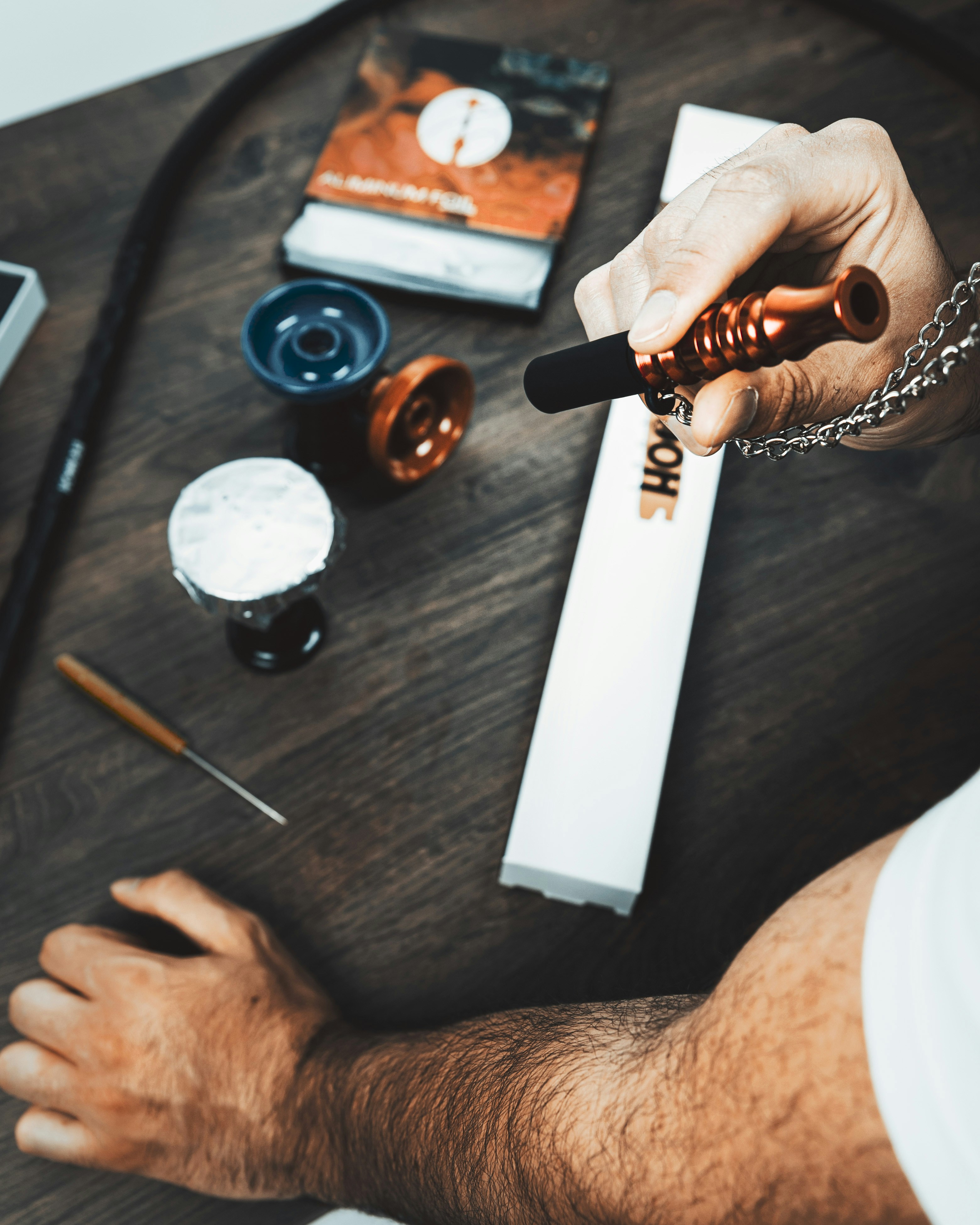 a person holding a pen on top of a wooden table