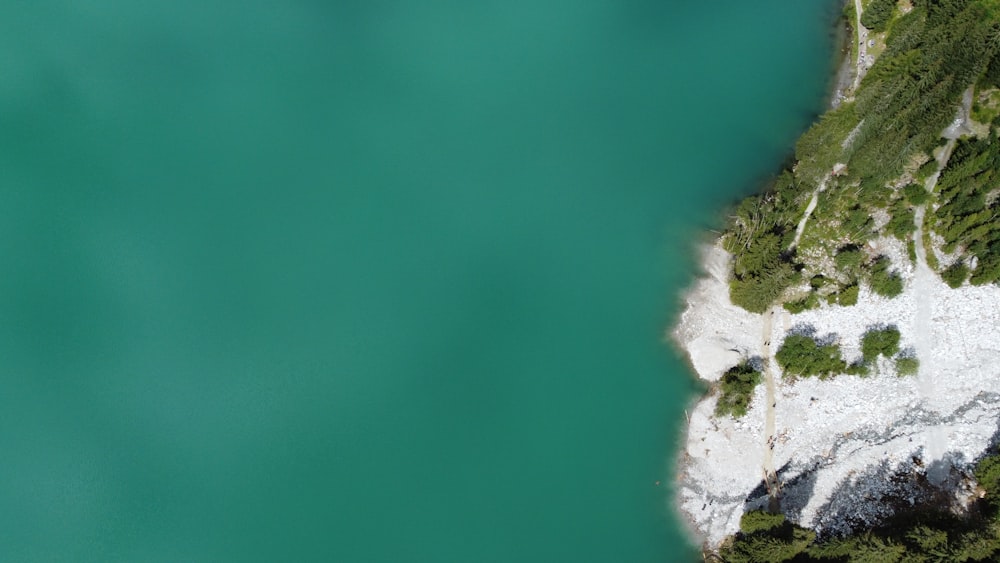 a bird's eye view of a lake and a cliff