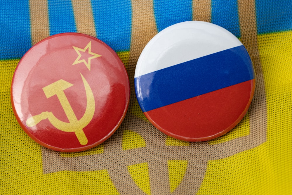 two buttons with the colors of the flag of the ussr and the hammer and sick