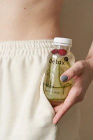 a hand holding a bottle
