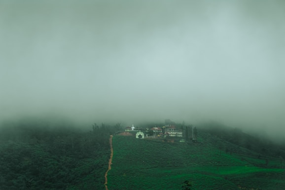 a house on a hill covered in fog