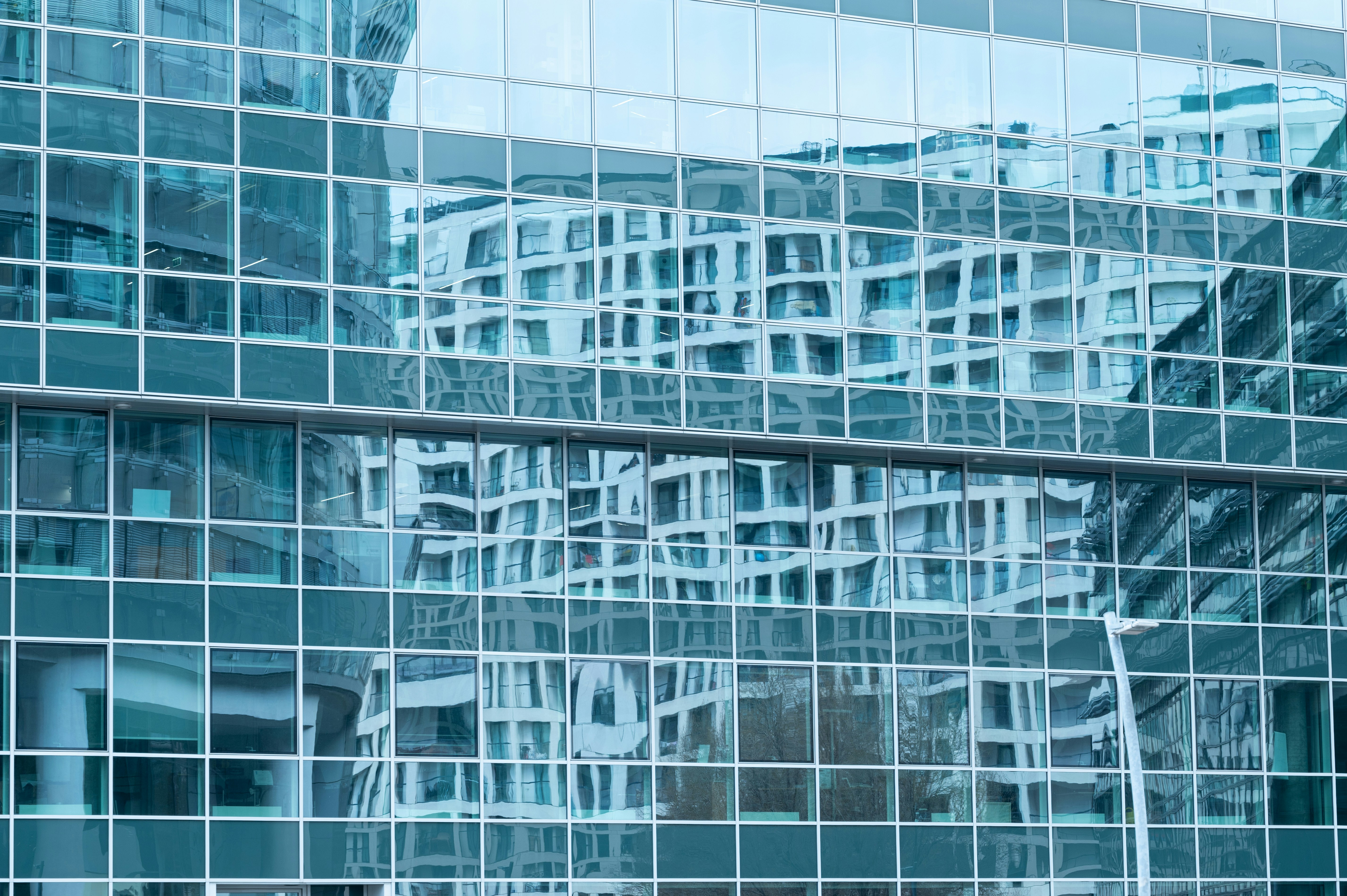 the reflection of a building in the windows of another building