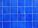 a close up of a blue tiled wall