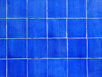 a close up of a blue tiled wall