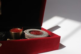 a red velvet box with a silver plate in it