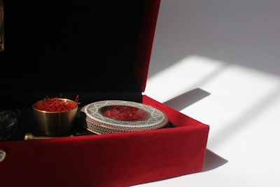 a red velvet box with a silver plate in it