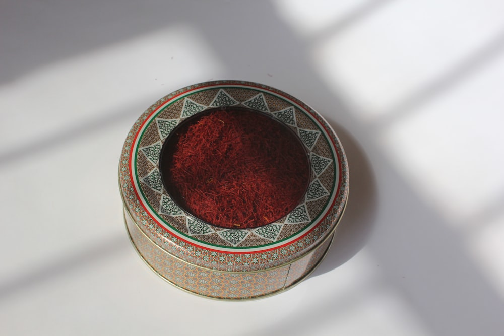 a bowl with a red substance inside of it