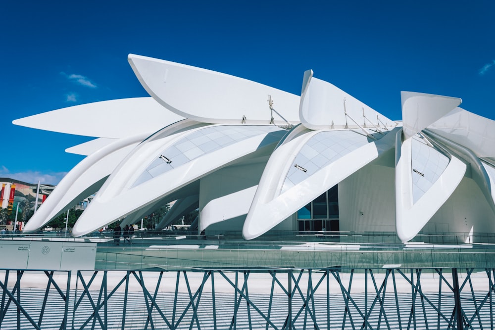 a large white building with a large white flower on top of it