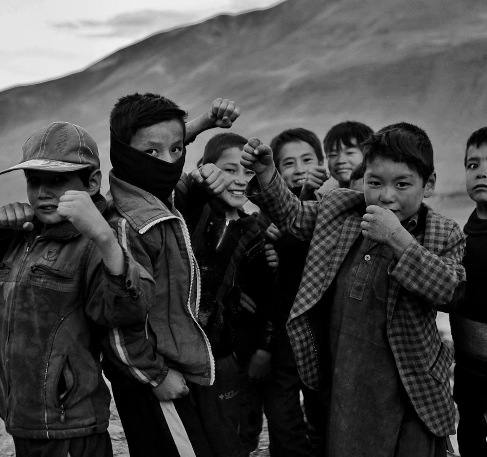 a group of young boys standing next to each other