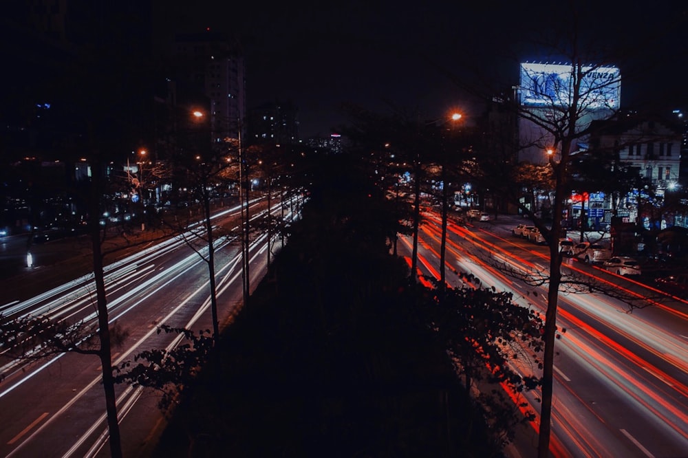 a city street filled with lots of traffic at night