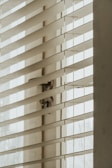 A close-up of a stylish roller blind in a cozy living room.