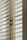 Close-up of finely crafted wooden plantation shutters partially open, letting in soft natural light.