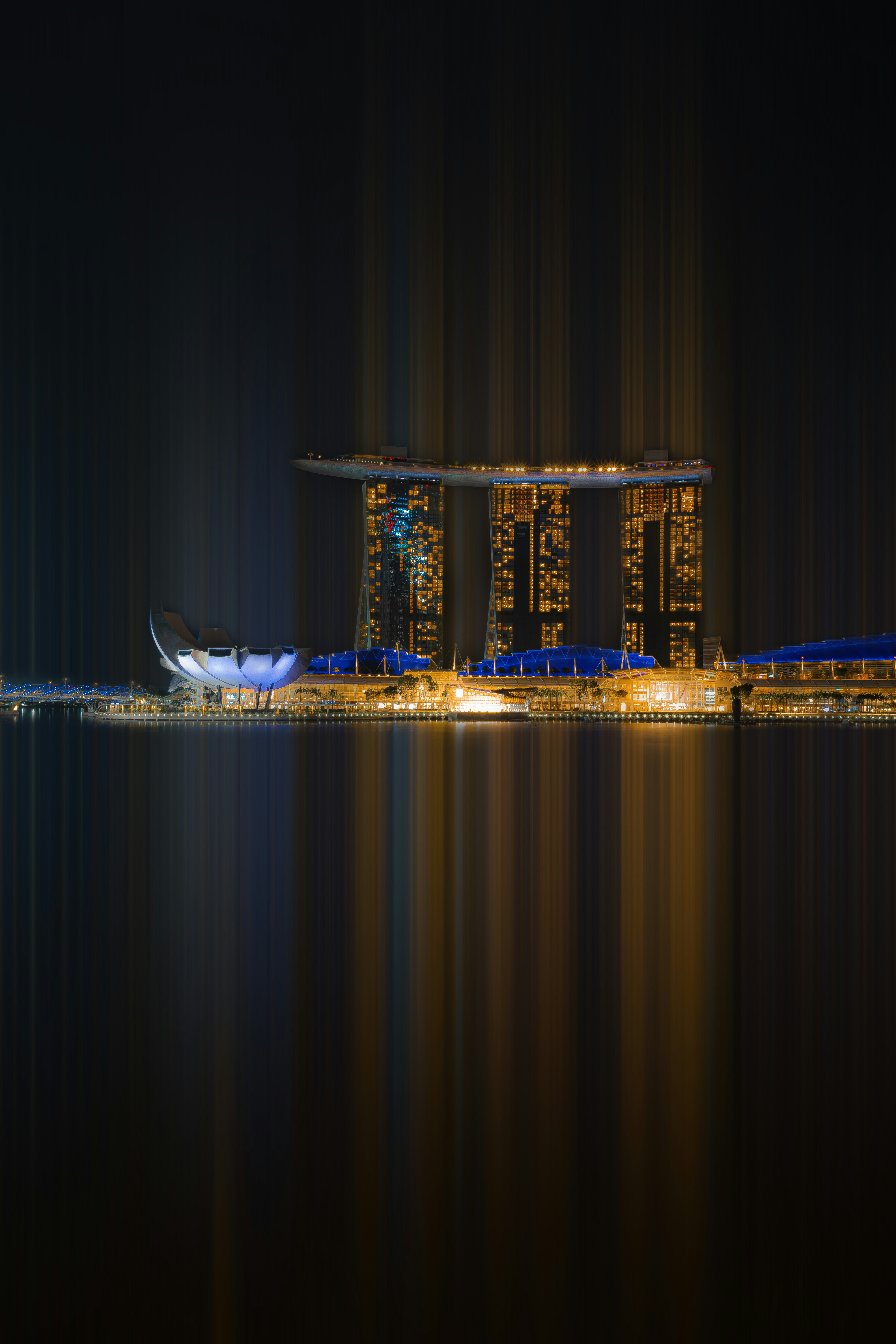 a night scene of a city with a large body of water