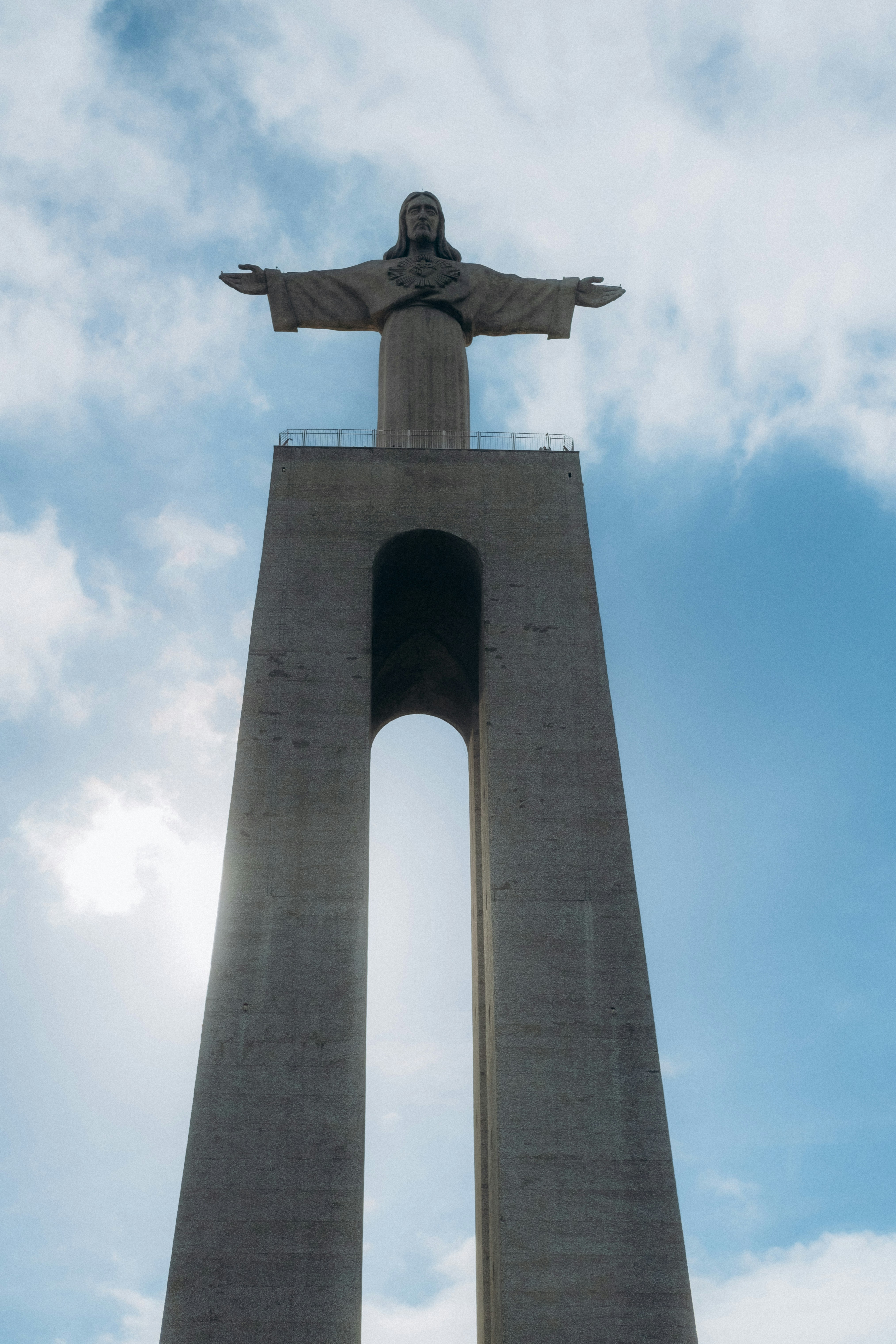 the statue of christ stands high in the sky