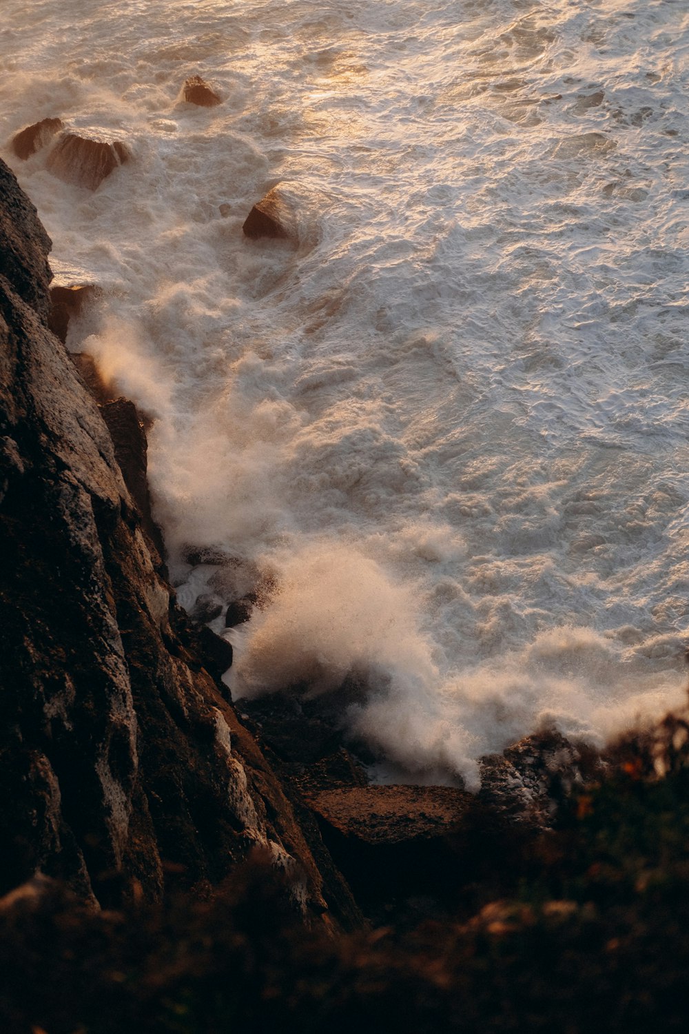 a person standing on a cliff near the ocean