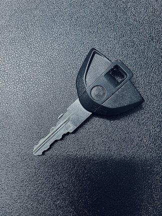 A locksmith working on a car key.