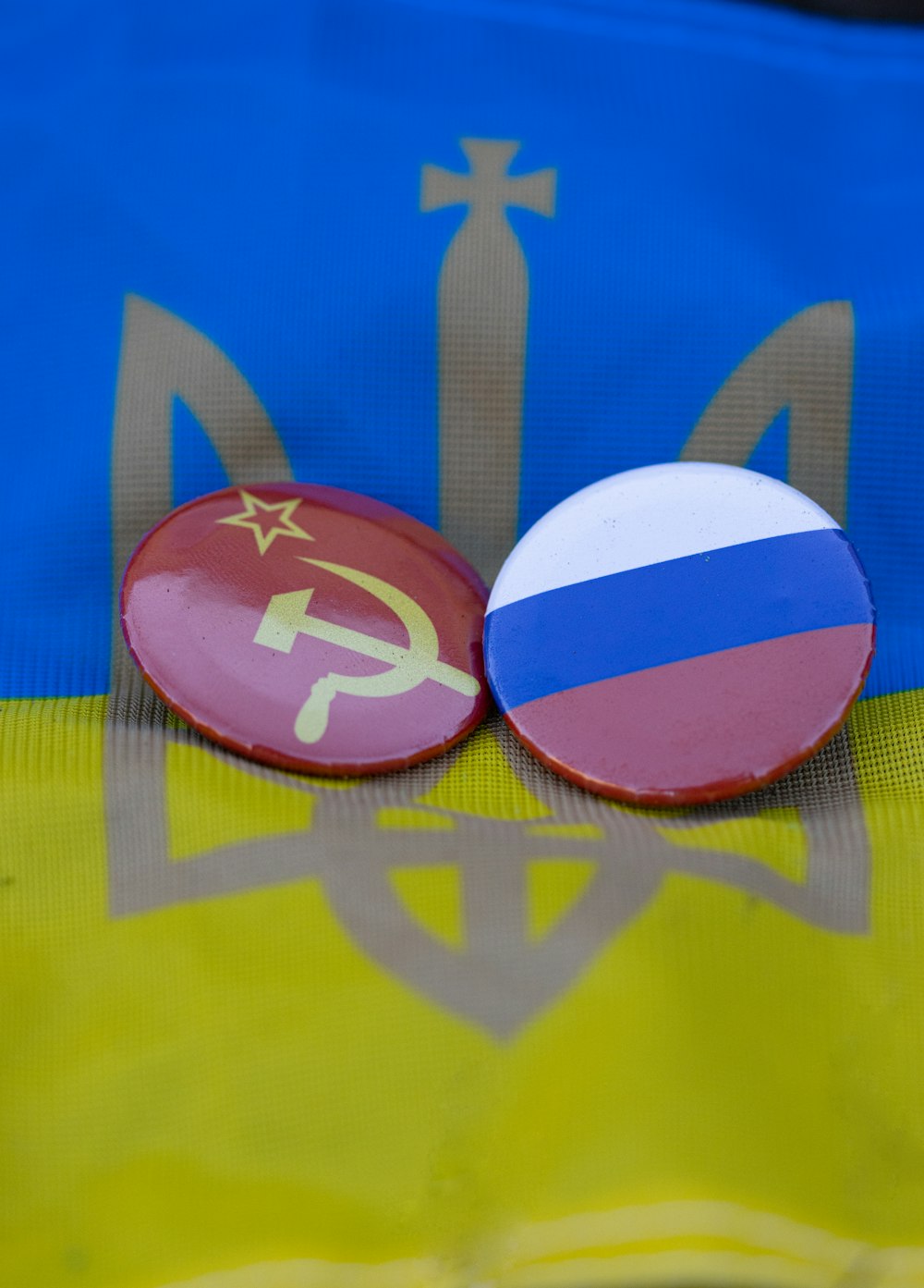 a pair of buttons with the flag of the ussr and the hammer and sick symbol