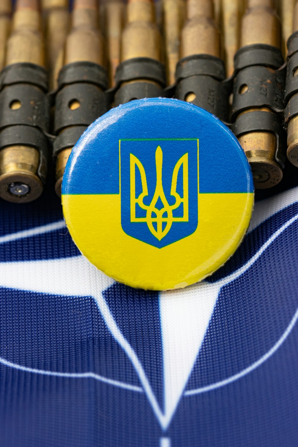 a blue and yellow button sitting on top of a table