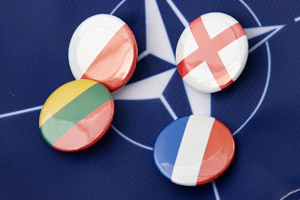 a group of buttons with a flag on them