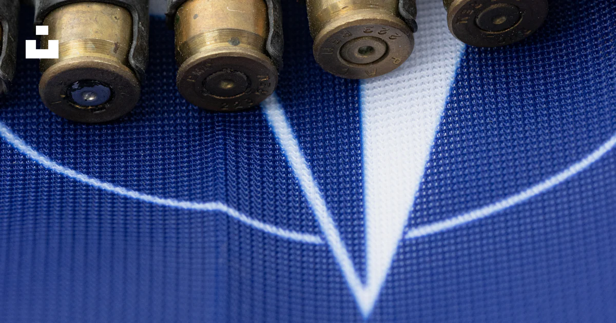 A bunch of bullet shells sitting on top of a table photo – Free ...