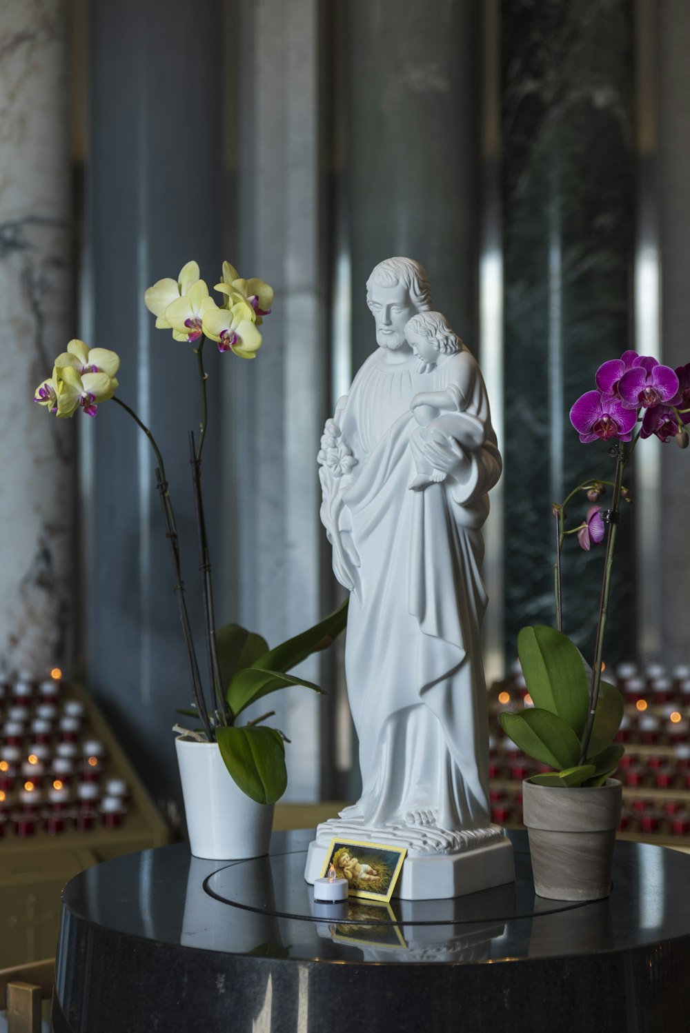 A statue of the virgin mary surrounded by flowers photo – Free ...