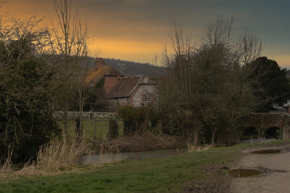 a house sitting on the side of a road next to a river