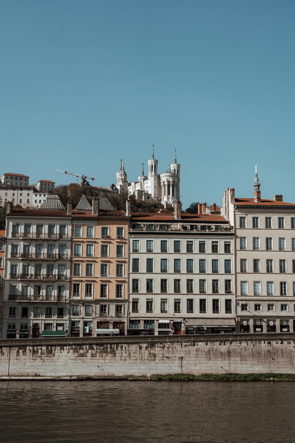 a row of buildings next to a body of water