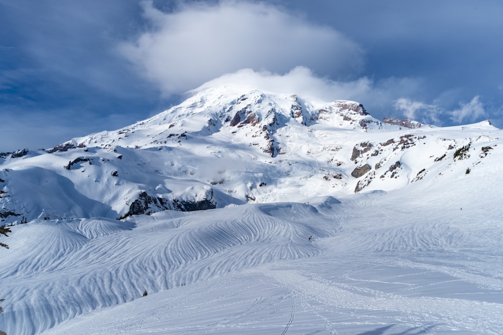 a snow covered mountain with a skier on it