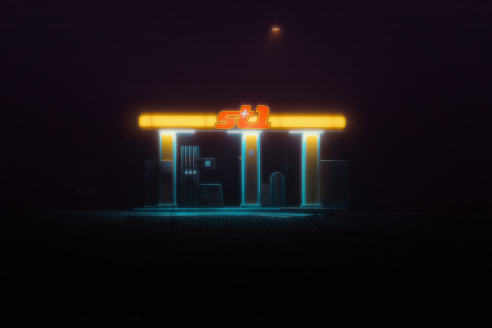 a gas station at night with the lights on