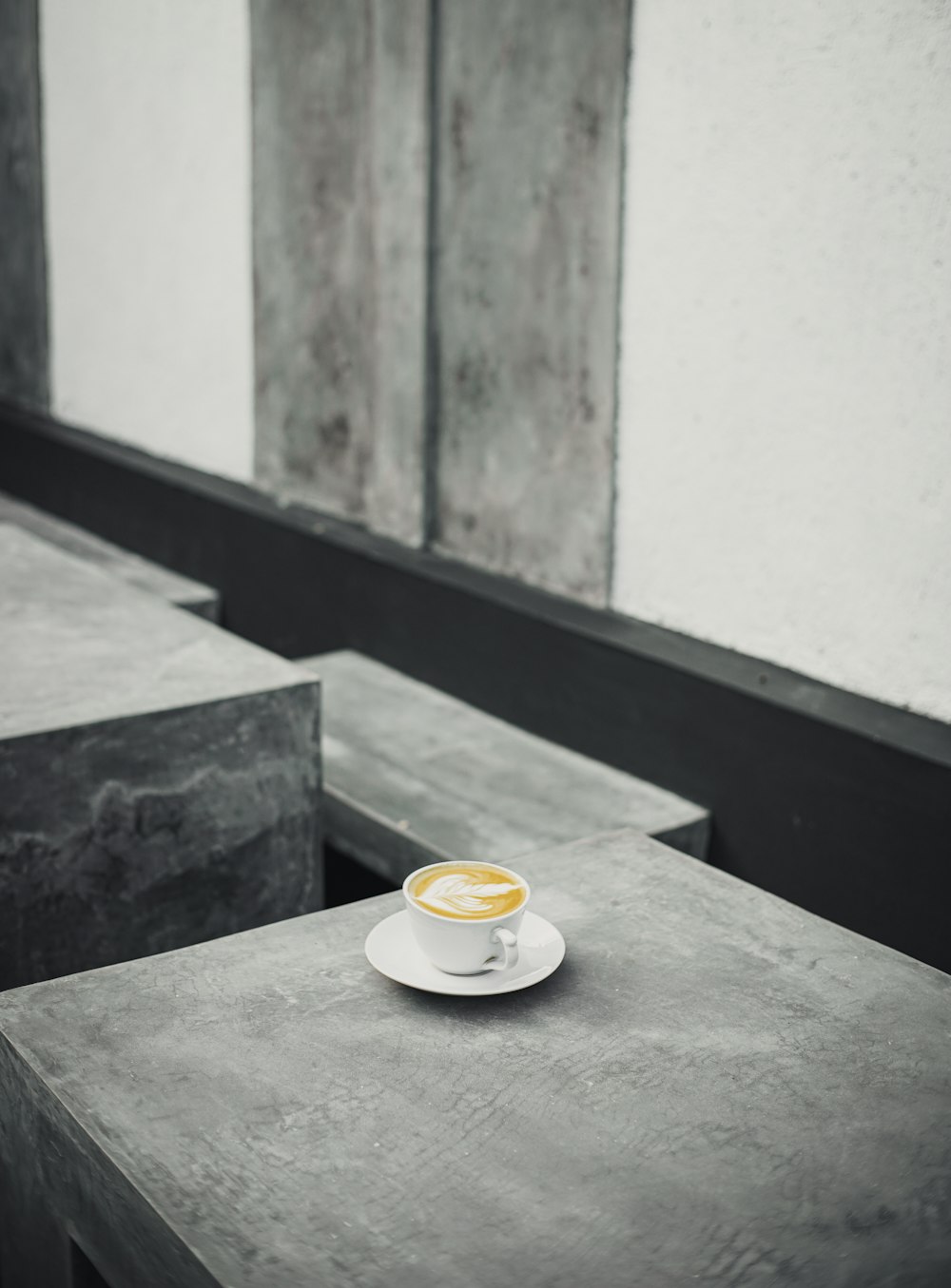 a cup of coffee sitting on top of a white saucer