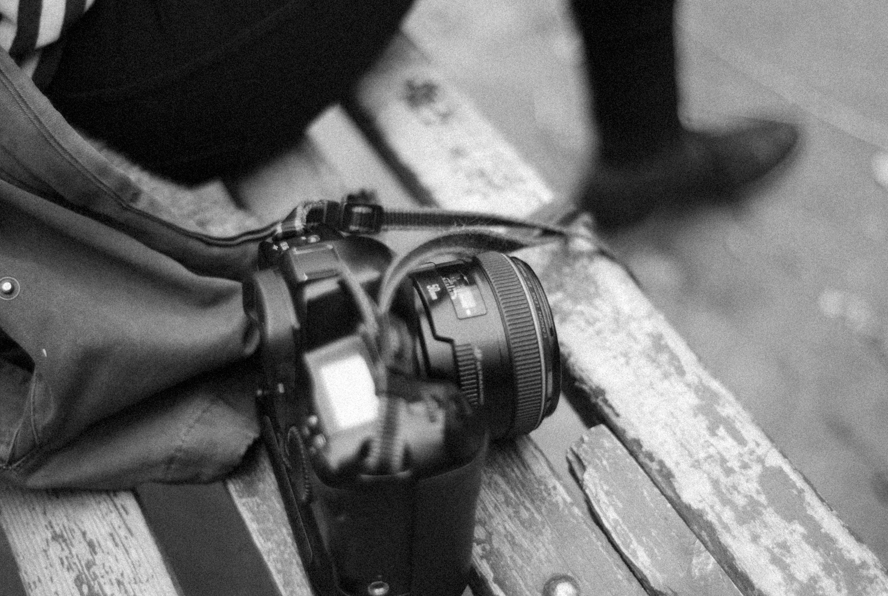 A camera sitting on top of a wooden bench photo – Free Camera Image on ...