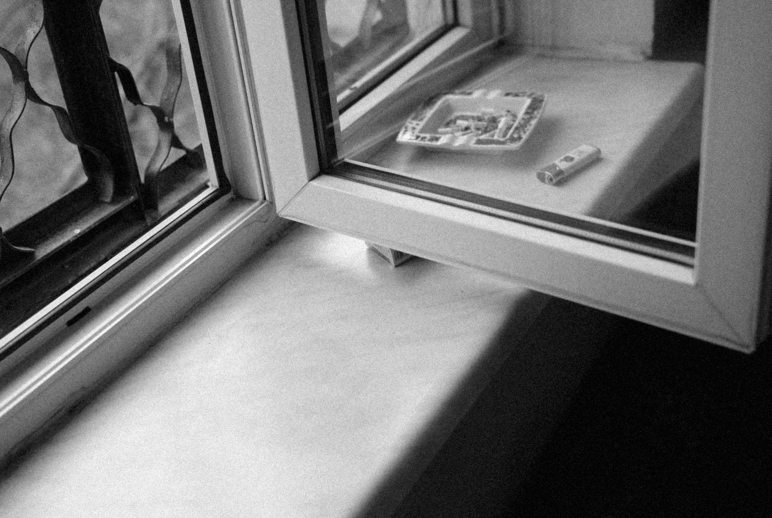 a broken cell phone sitting on a window sill