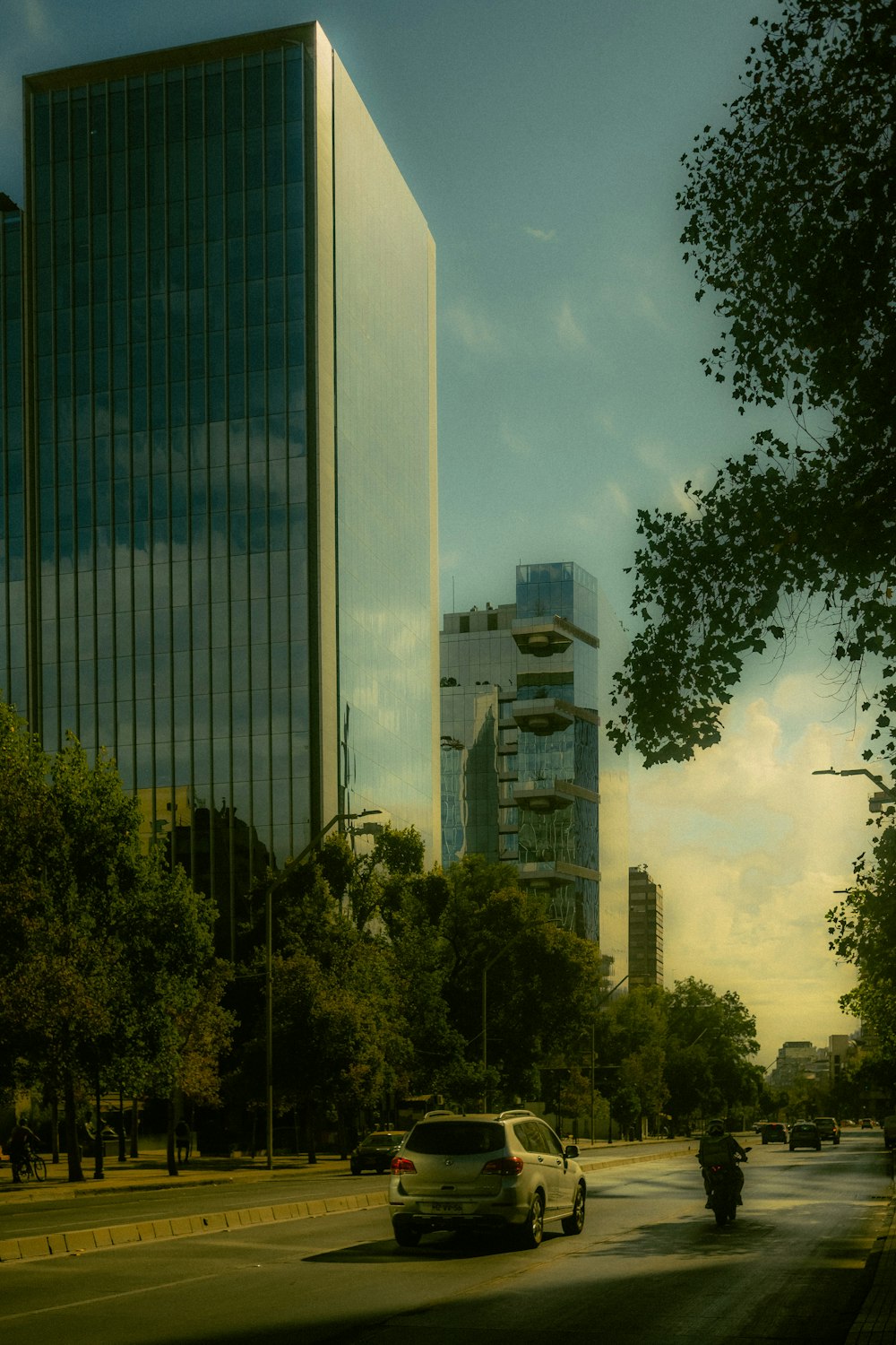 a car driving down a street next to tall buildings