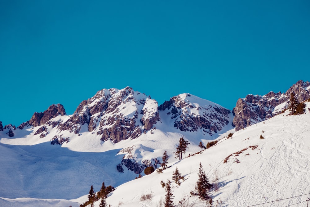 a mountain covered in snow with a sky background