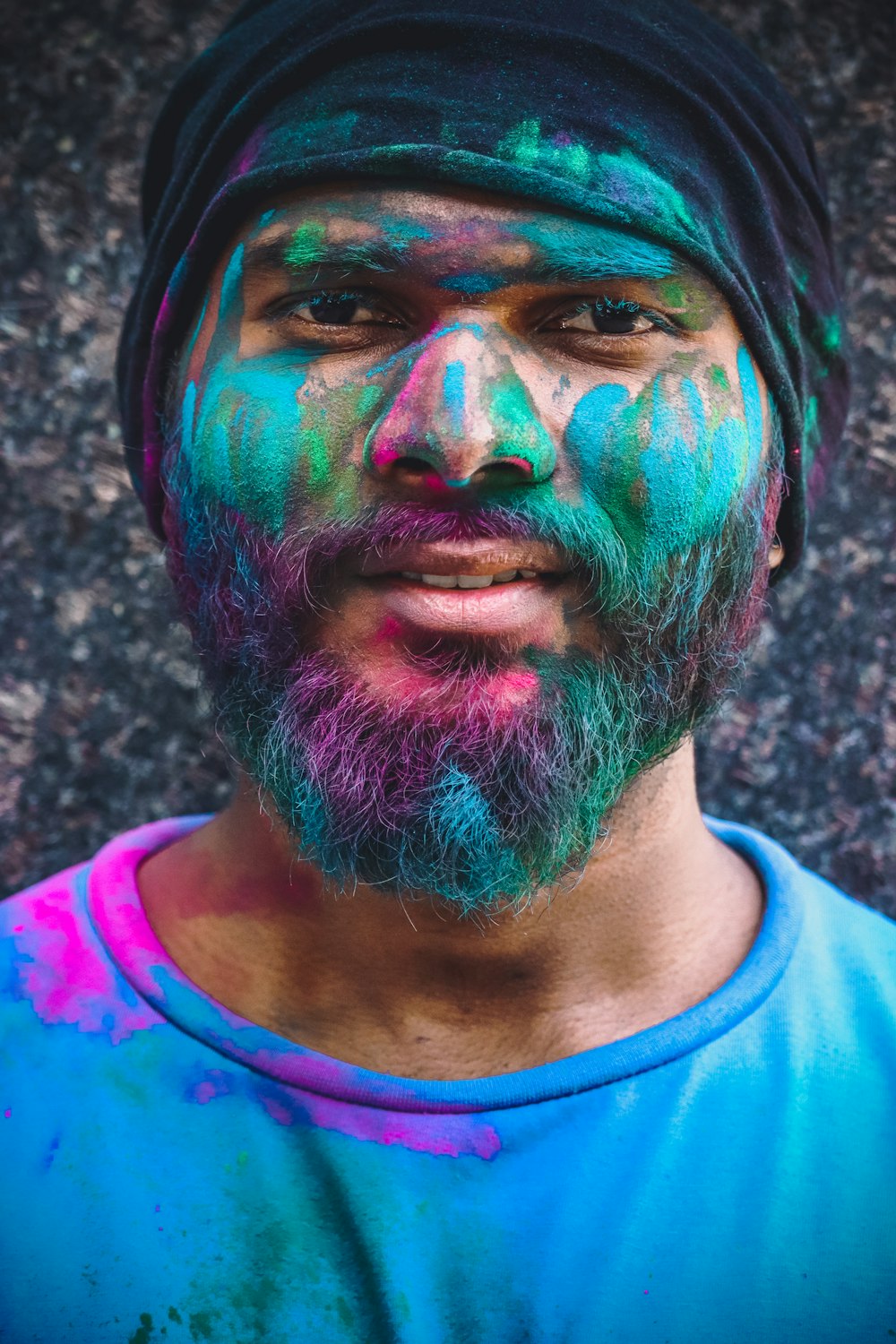 a man with a beard wearing a blue shirt and a turban