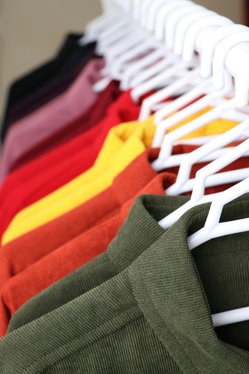 a row of shirts hanging on a rack