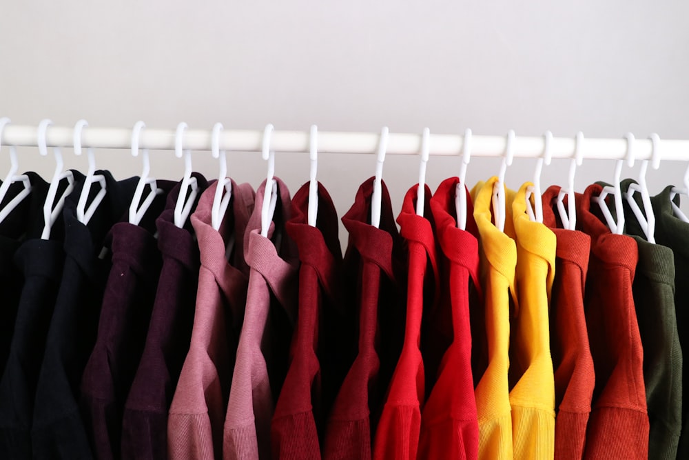 a rack of shirts hanging on a rail
