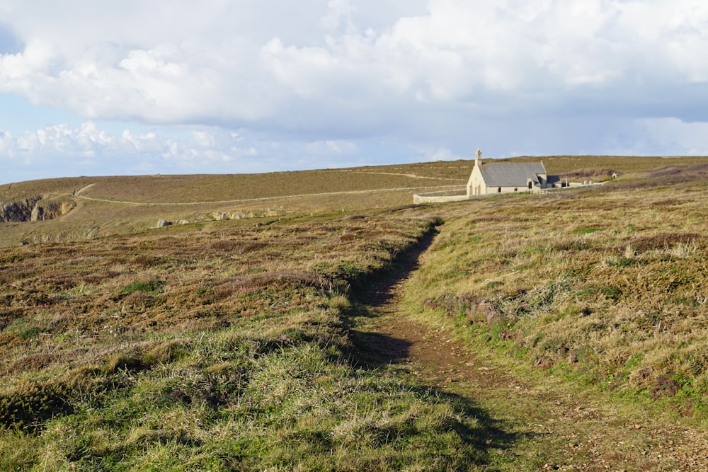 a house on a hill with a path leading to it