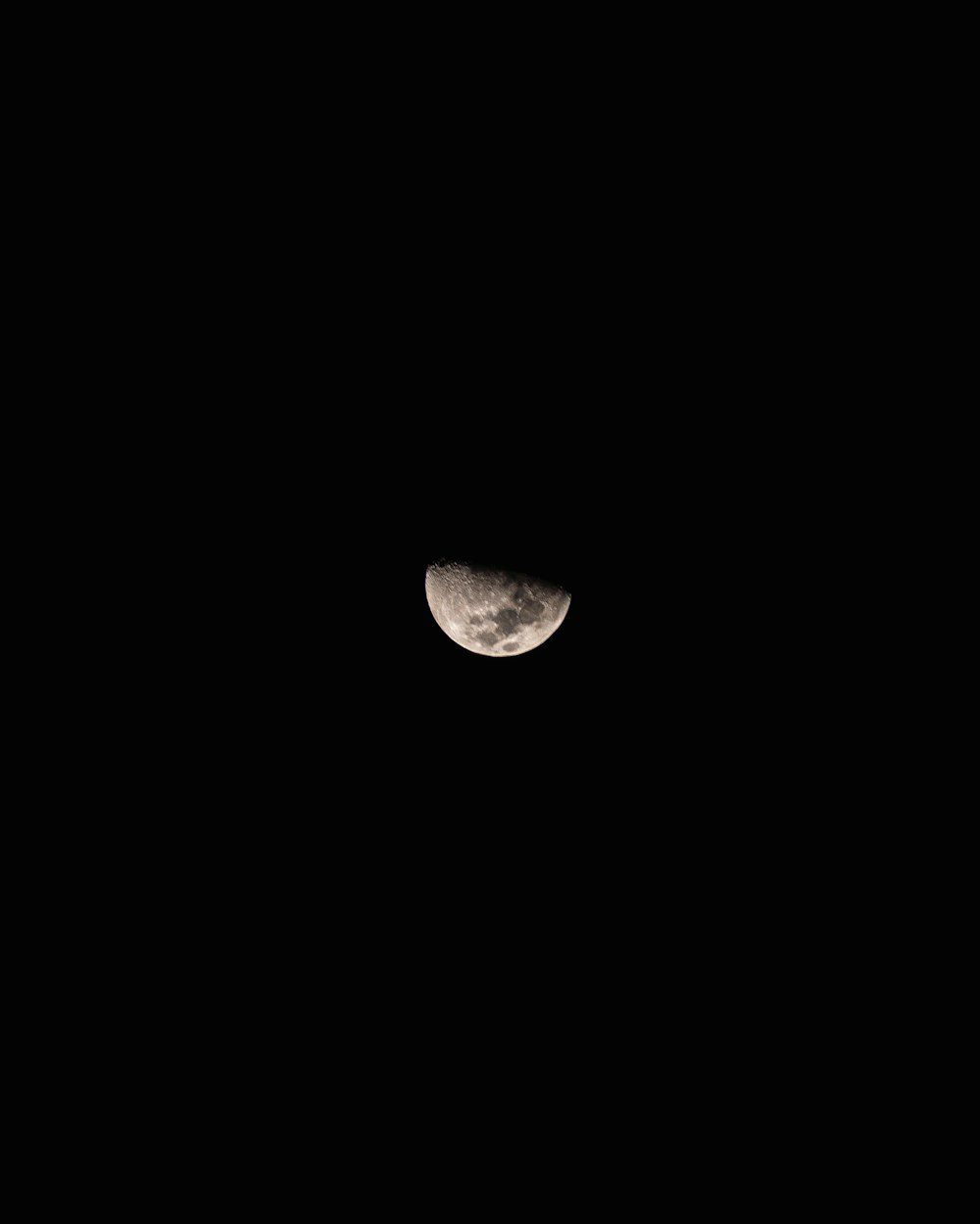 the moon is seen through the dark night sky