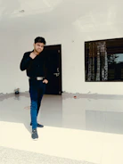 A confident security guard standing at a modern building entrance.