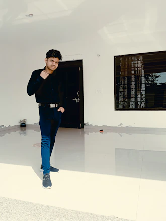A professional security guard standing confidently at a commercial building entrance.