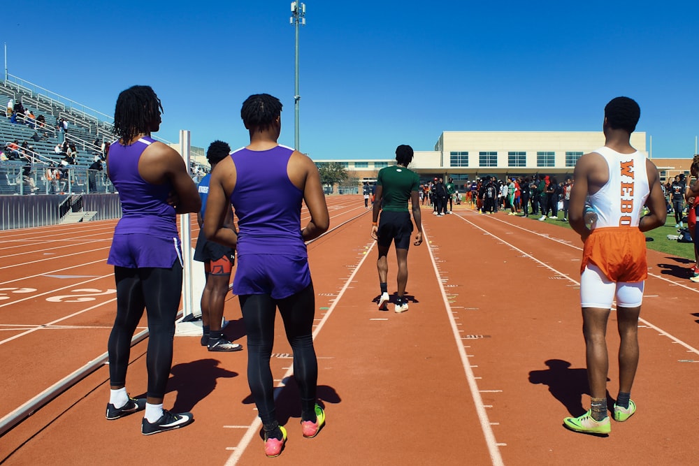 a group of people standing on top of a track