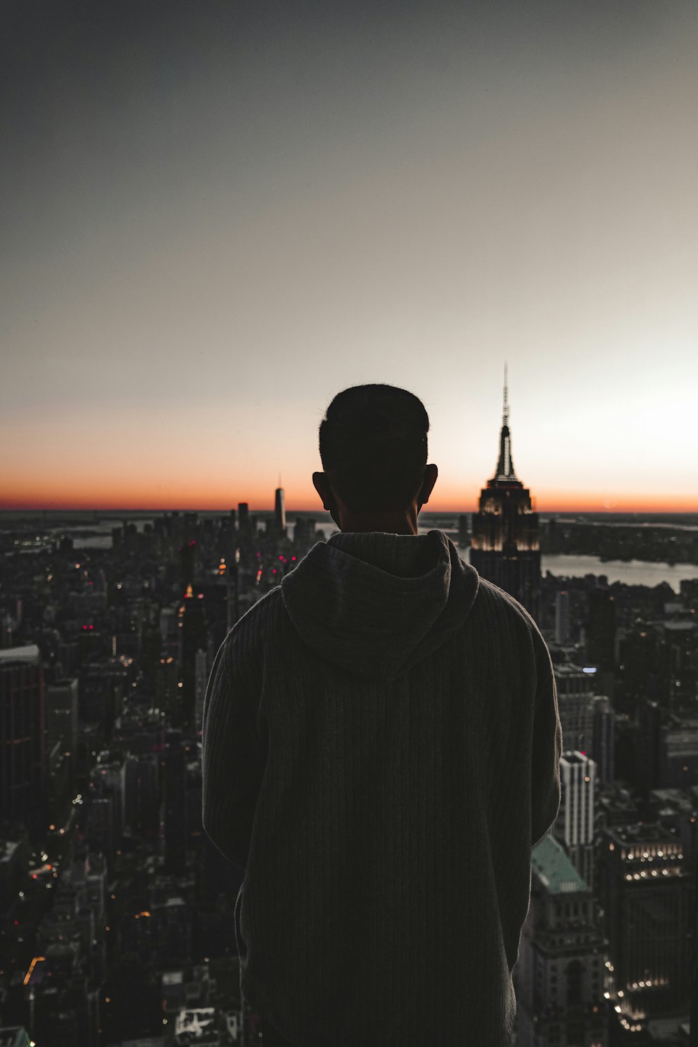 a man standing on top of a tall building